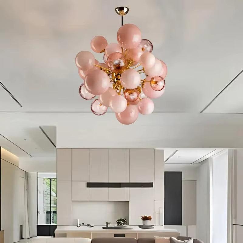 Modern pink bubble glass chandelier with metal frame and LED bulbs in stylish living room setting