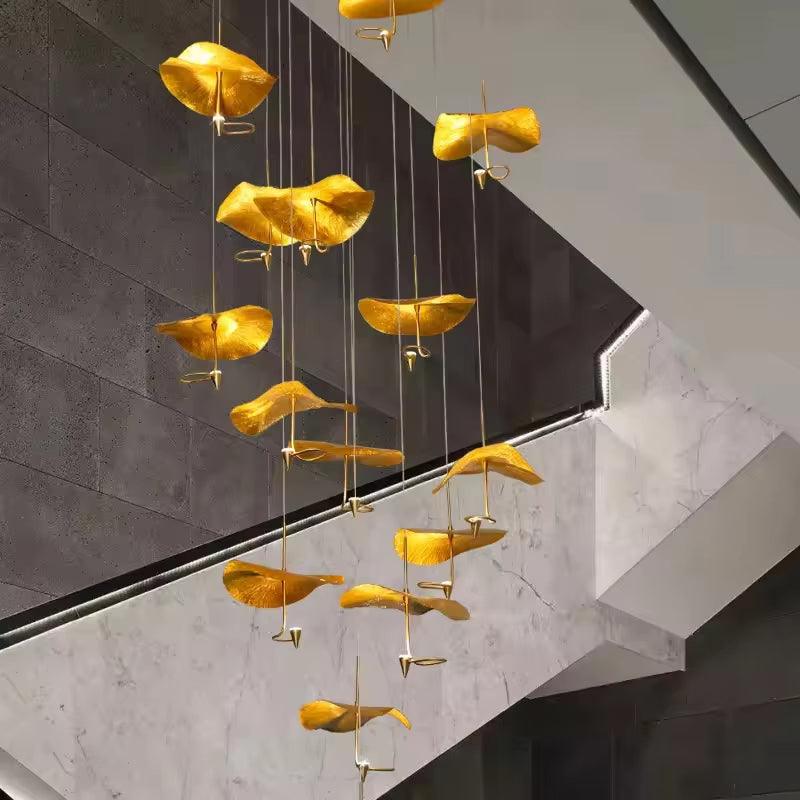 Copper gold lotus stair chandelier with LED lights hanging in modern interior