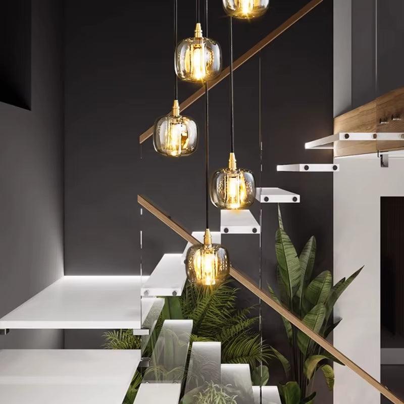 Modern bubble crystal lamp with multiple hanging glass orbs illuminating a stairwell interior