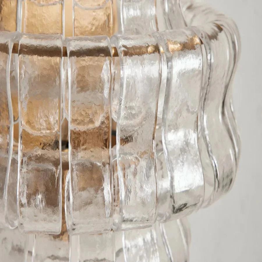 Ghiaccio Glass Wall Sconce with antique brass finish and textured glass design.