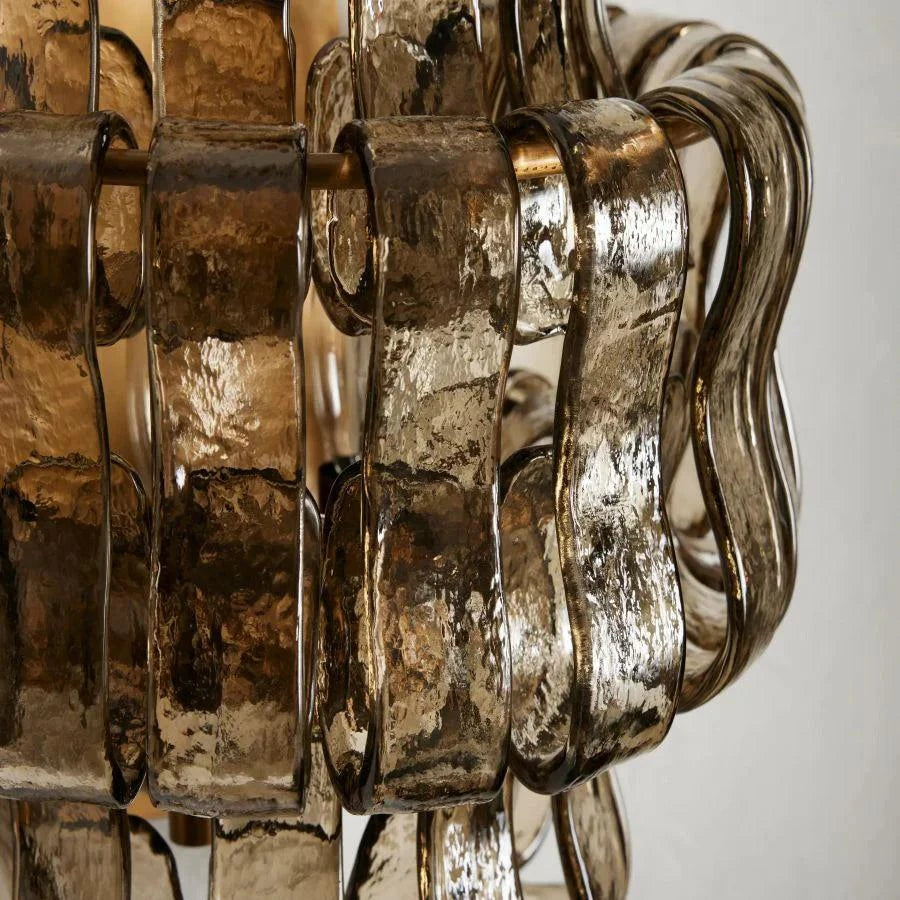Ghiaccio Glass Wall Sconce with antique brass finish and glass details.