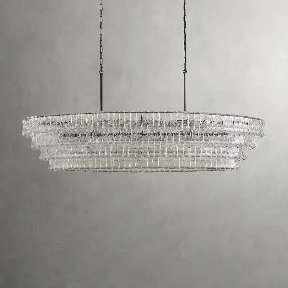Ghiaccio Glass Oval Chandelier with metal frame and hanging chain in modern design.