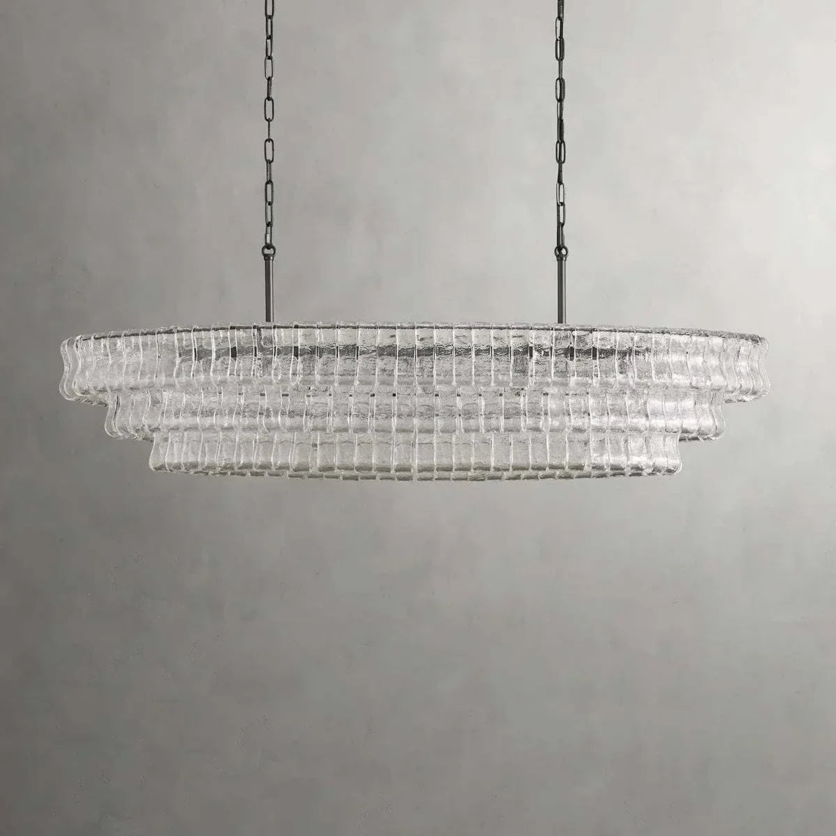 Ghiaccio Glass Oval Chandelier with metal accents and glass design.