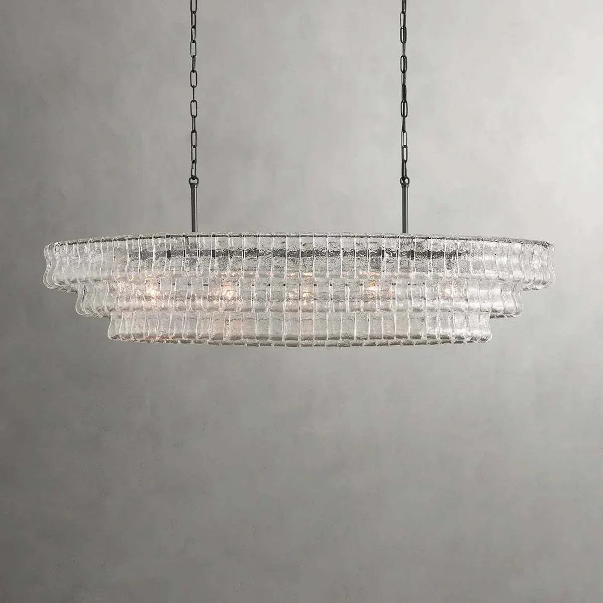Ghiaccio Glass Oval Chandelier with metal frame and E12 bulbs, ideal for dining rooms and living areas.