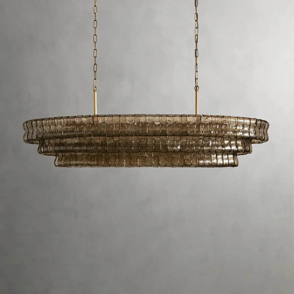 Ghiaccio Glass Oval Chandelier with metal frame and glass accents.