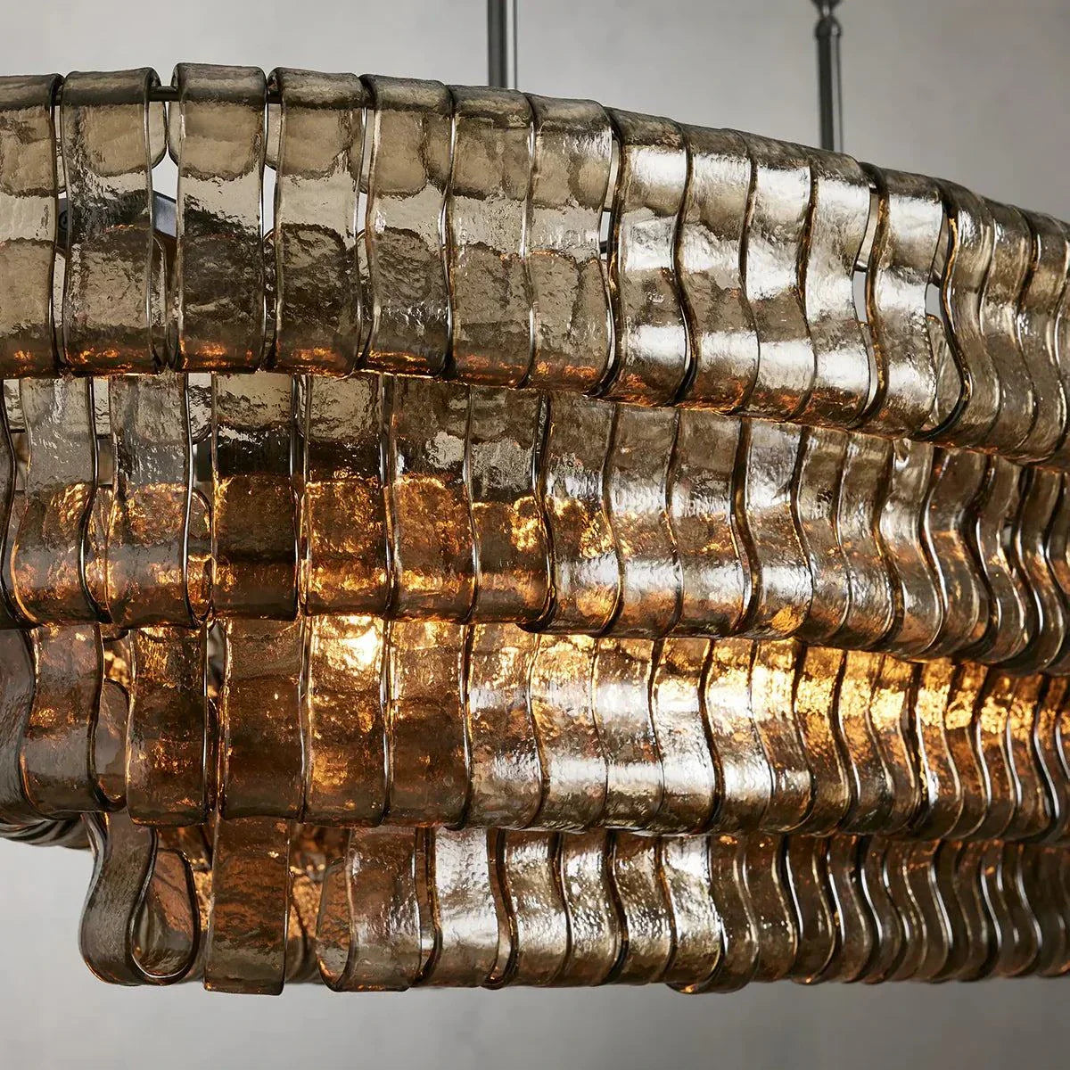 Ghiaccio Glass Oval Chandelier with textured metal and glass design.