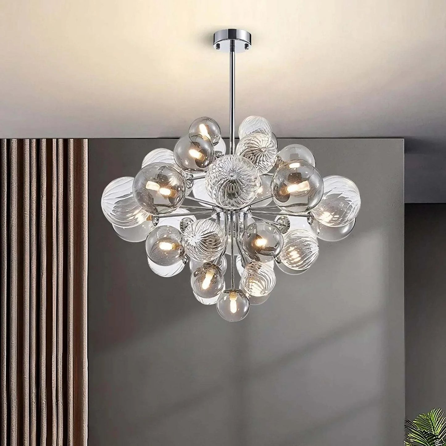 Modern glass bubble chandelier with chrome finish and LED bulbs, surface-mounted in a contemporary room.