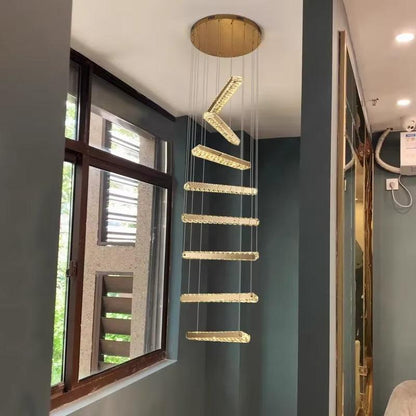 Modern spiral staircase LED chandelier with gold and glass design hanging in living room