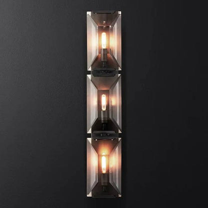 Crystal wall sconce with three lights, metal and crystal design, warm white illumination.