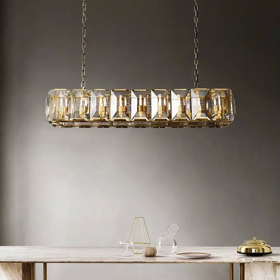 Farmhouse crystal rectangular chandelier with gold metal frame and glass panels hanging above dining table