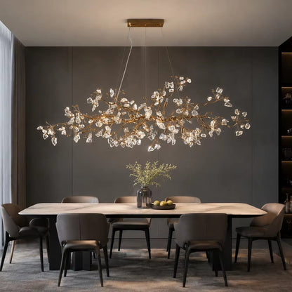 Handcrafted copper branch chandelier with crystal accents in antique gold finish hanging in modern interior