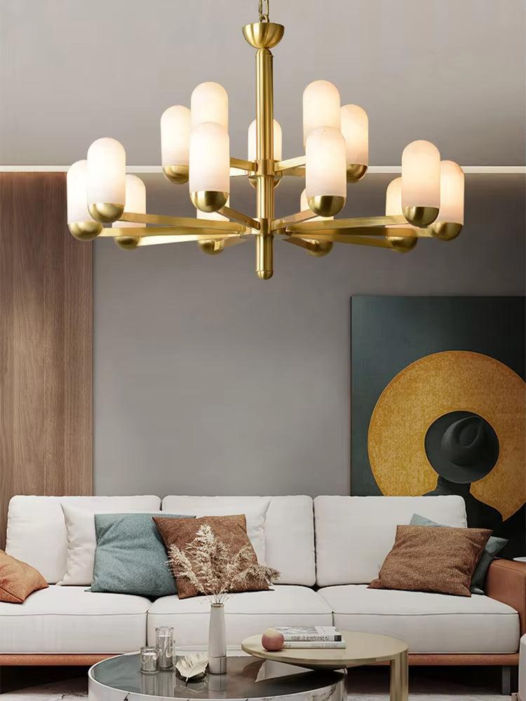 Spanish marble chandelier with brass frame and frosted glass lights hanging above a modern living room sofa