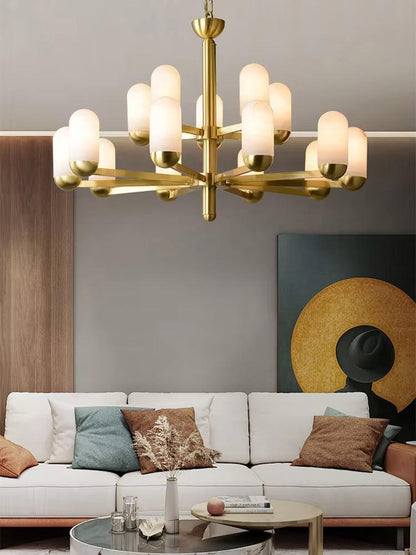 Spanish marble chandelier with brass frame and frosted glass lights hanging above a modern living room sofa