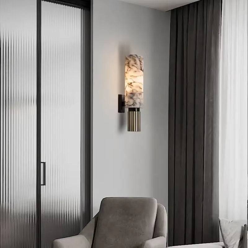 Natural marble sconce with black metal body illuminating a modern living room.