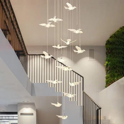Modern bird acrylic chandelier with LED lights hanging in staircase foyer