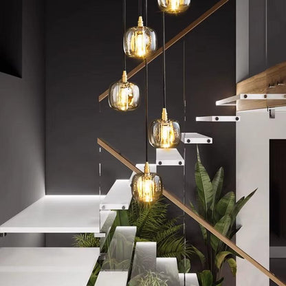 Modern bubble crystal lamp with multiple hanging glass orbs illuminating a stairwell interior