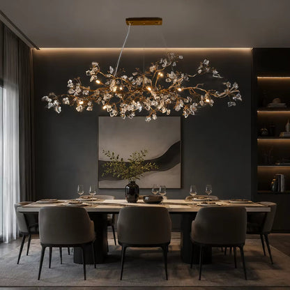 Handcrafted copper branch chandelier with crystal accents and warm light in antique gold finish