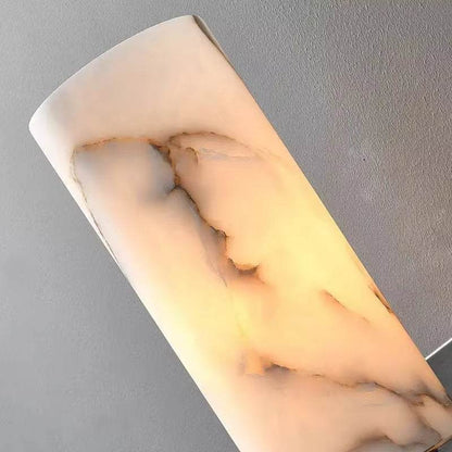 Natural marble sconce with black metal body and warm LED light.