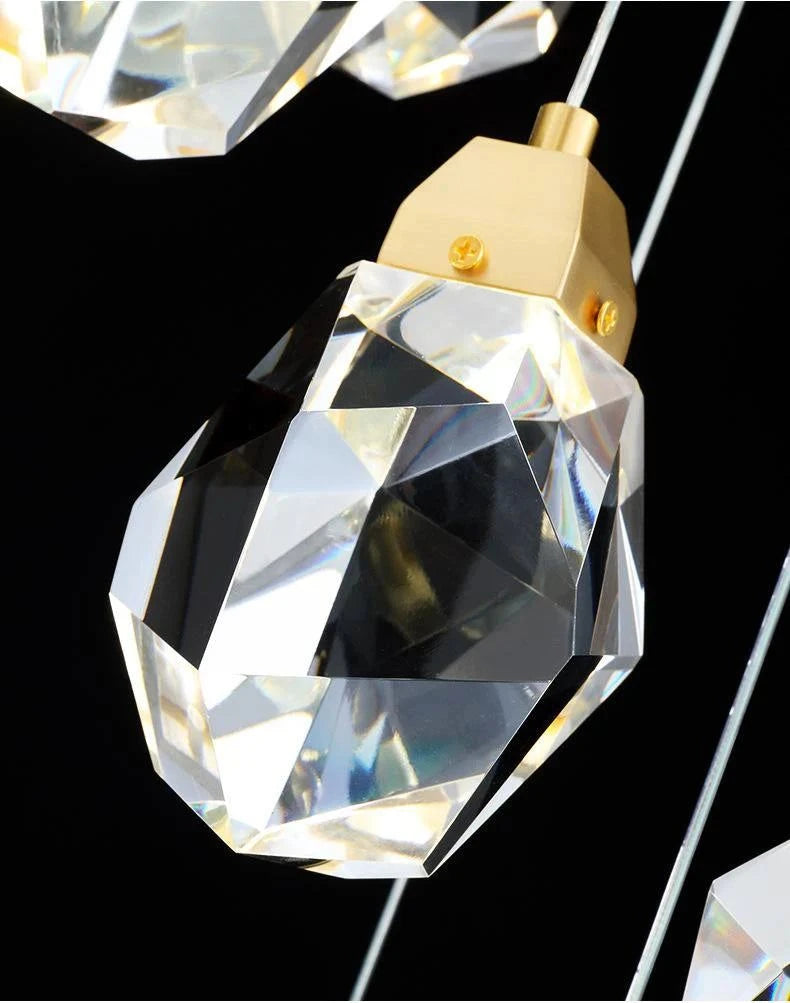 Crystal stone detail of a modern staircase chandelier with gold finish.