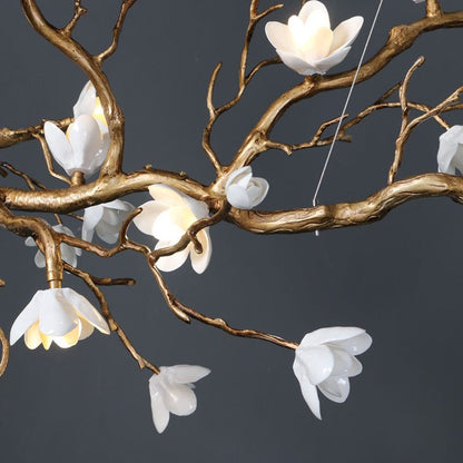 Luxury brass ceramic chandelier with white ceramic flower accents.